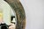 Rare round Italian wall mirror in patinated copper from the mid-20th century; a larger model exists in very good...