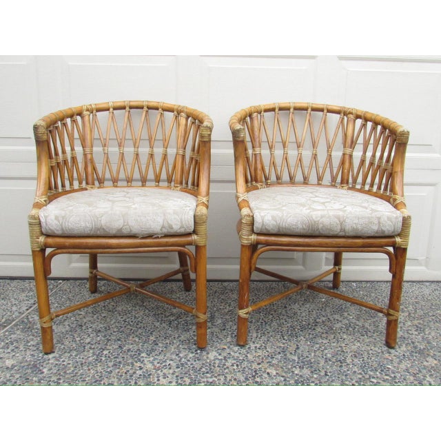 Pair of vintage McGuire rattan barrel-back armchairs, c.1980’s These chairs feature the classic curved spindle back in an...