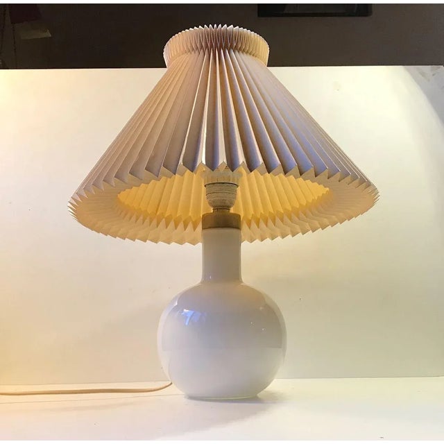 A vintage hand blown table Lamp in cased white glass by Holmegaard Denmark. Designed in-house at Holmegaard in Denmark...