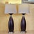 Pair of contemporary hourglass-form table lamps featuring espresso wood-look bodies, brushed nickel-tone accents and...