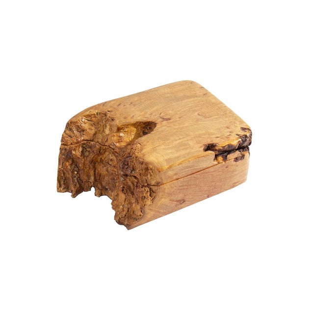 A dresser box carved from burlwood. The box has a natural wood edge and the interior and underside of the box is felt...