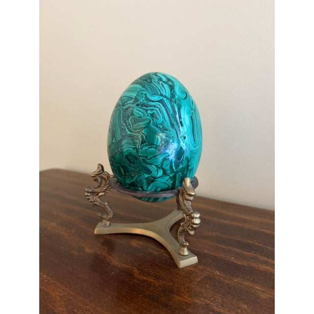 A stunning Russian style large malachite egg on Neoclassical style stand Late 20th century Solid malachite egg, with cast...