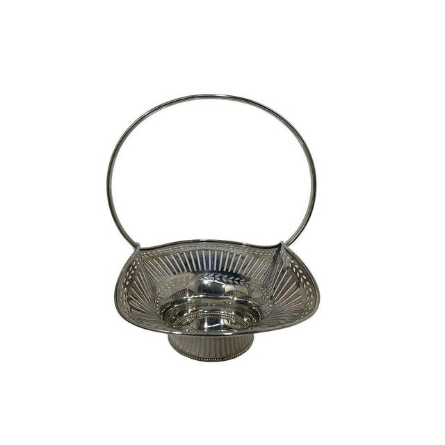 German silver basket by Lutz & Weiss An elegant basket with a fixed handle, raised on a round base. The graceful scalloped...