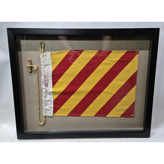 International maritime signal flag of letter 'Y', 'YANKEE,' set into a shadowbox frame. The cotton flag has a white canvas...