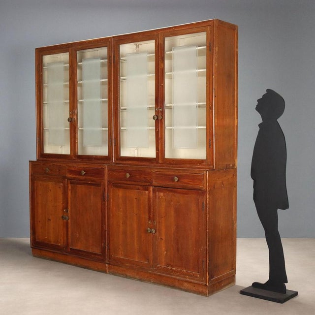 Larch bookcase. Structure composed of four blocks. The upper part features glass doors with etched inserts, and adjustable...