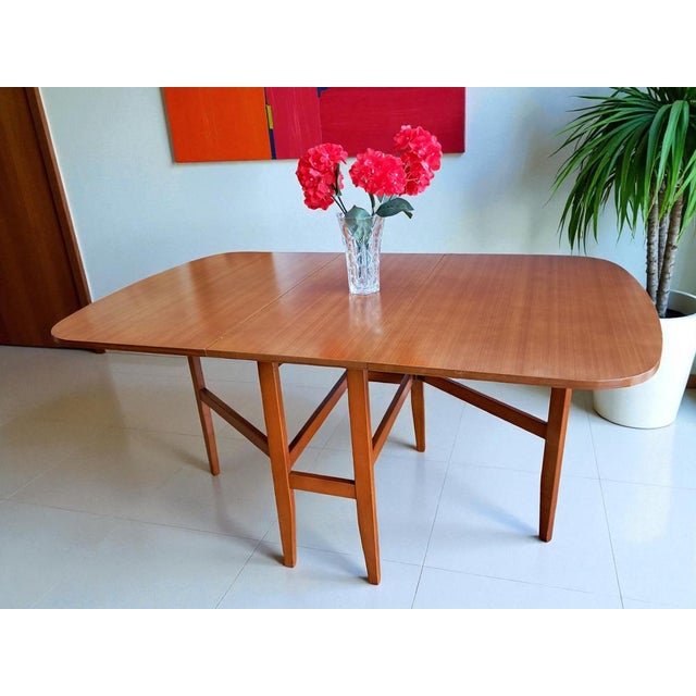 Introducing our stunning vintage Mid Century teak Gate Leg / Drop Leaf Dining Table! This beautiful piece sits on retro...
