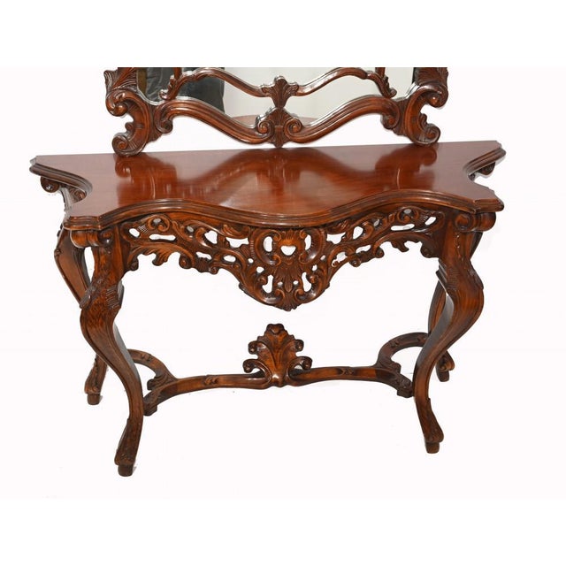 Gorgeous hand carved Italian console table and matching mirror set. Very intricately carved in the rococo style. Great for...