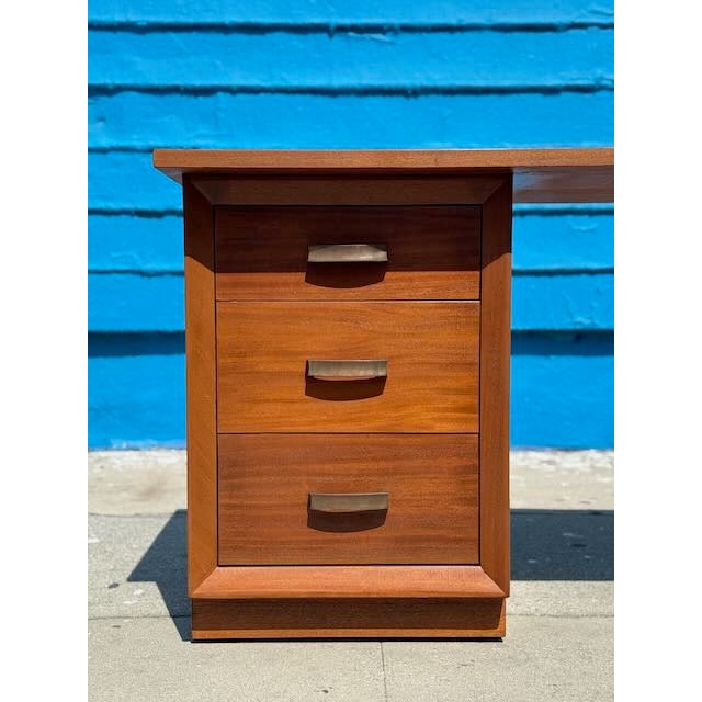 Bring timeless elegance to your workspace with this fully restored 1950’s solid mahogany writing desk. Featuring a warm,...