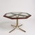 This mid century dining table is a stunning Italian octagonal dining table that combines smoked glass, brass, and teak...