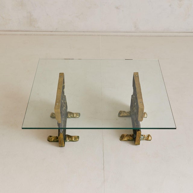 A rare 1970s cast bronze coffee table attributed to Valenti, Barcelona. The sculptural twin bases are rendered in richly...