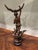 A beautifully aged antique spelter figure mounted on a turned wood base, offered as an evocative piece of architectural...