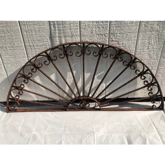 Antique wrought iron decorative Transom or window guard. Lovely half moon shape with detailed scroll work. It has been...