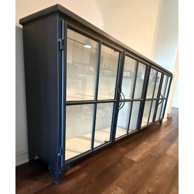 Bring an industrial-chic edge to your dining or living space with the Marjorie Curio Sideboard from Lulu and Georgia. This...