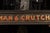 American 1918 Goodman and Crutchfield Reverse Painted Glass Sign For Sale - Image 3 of 5