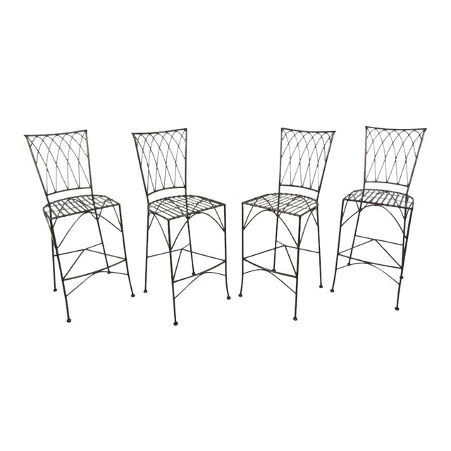 Four vintage-modern stools with sturdy sculpted iron construction, comes with removable tufted seat cushions. Condition:...