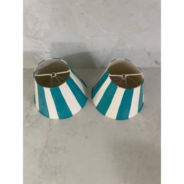 Fun pair of metal lamp shades for candle lamps or sconces. Each painted with white with aqua stripes. Fun for a powder...