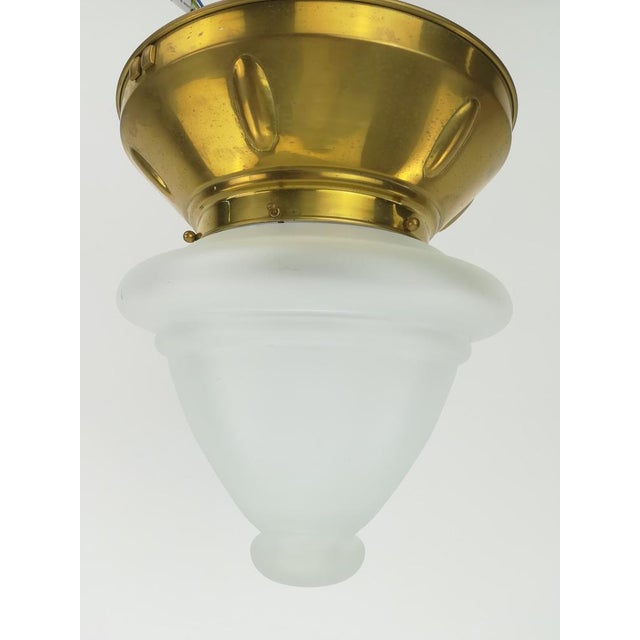 Wiener Werkstätte Massive brass ceiling lamp hammered out of one piece. Satin.The lamp gives a cozy non-dazzling light....