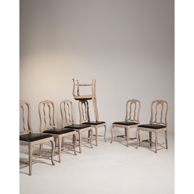 This exceptional set of twelve dining chairs embodies the graceful refinement of the Louis XV style, characterized by its...