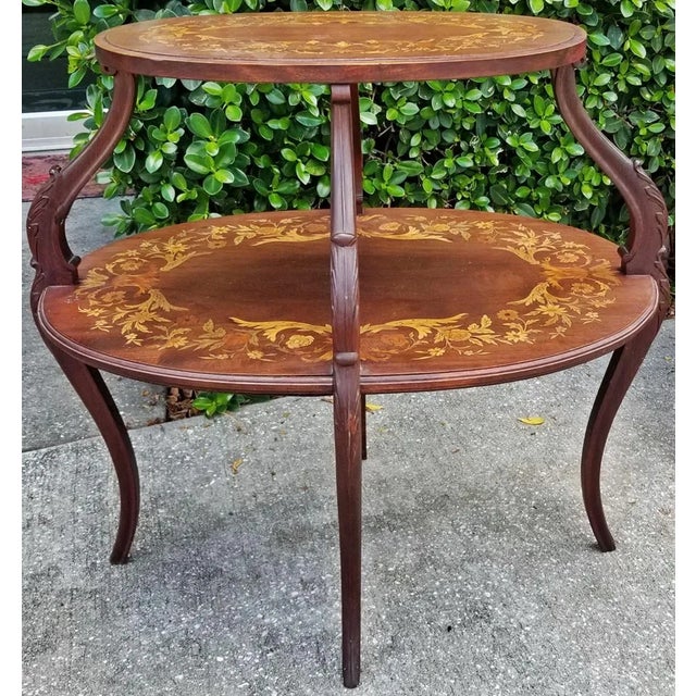 Classic Dutch inlaid mahogany 2 tier tea table with marquetry inlay on both levels. Cabriole legs with acanthus leaf carving.