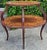 Classic Dutch inlaid mahogany 2 tier tea table with marquetry inlay on both levels. Cabriole legs with acanthus leaf carving.