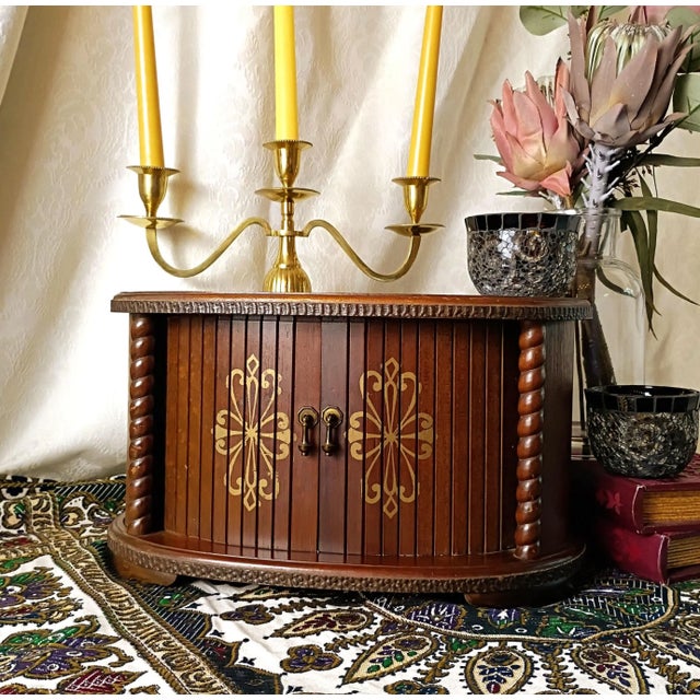 This mid-century Kellerman wooden jewelry armoire box features an architectural oval silhouette with functional sliding...