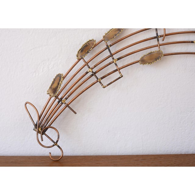 Rare vintage metal wall sculpture featuring a wavy musical staff and notes. Made of copper and brass with 2 hooks on the...