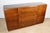 A superb Art Deco sideboard dating from the 1940s/1950s, crafted from varnished rosewood in warm, deep tones, revealing an...