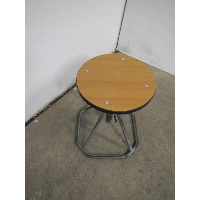 Adjustable manually in height. Black border. In good condition clean and treated with iron paint.