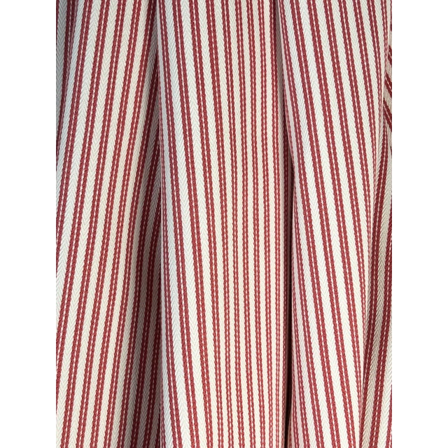 A red and white cotton ticking stripe with a tiny white herringbone pattern between the red warp stripes. The overall...