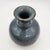 Studio pottery weed pot with bulbous body, flared neck, and smooth blue-gray glaze with iron-oxide rim