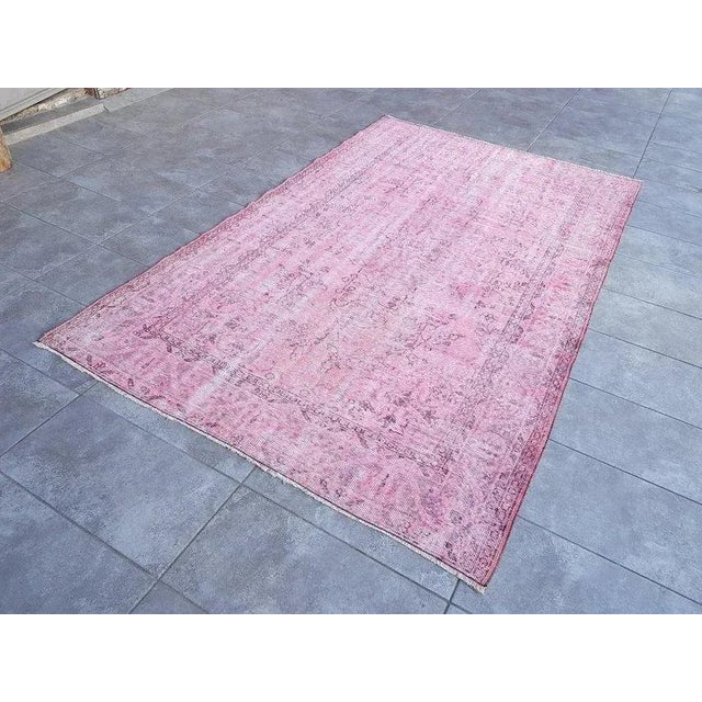 This is a vintage Turkish Oushak rug from the 1960s. The piece was hand-knotted.