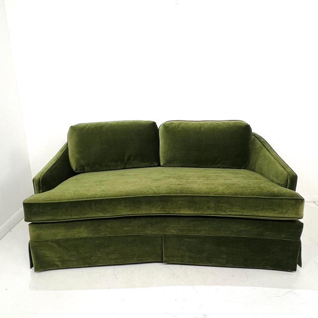 A beautifully shaped vintage curved loveseat upholstered in rich green Schumacher velvet. The silhouette features a...