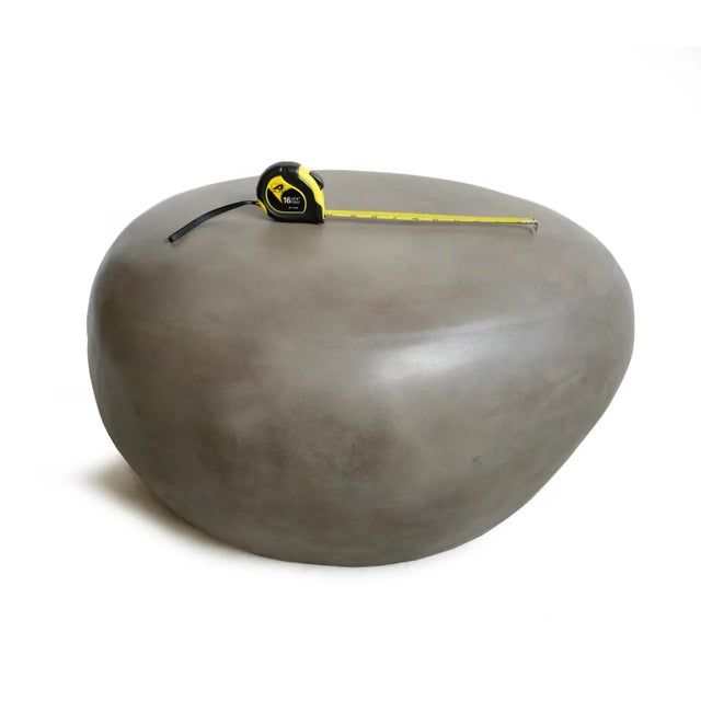 Organic modern style coffee or side table or stool in the shape of a pebble. Made from lightweight cement resin and works...
