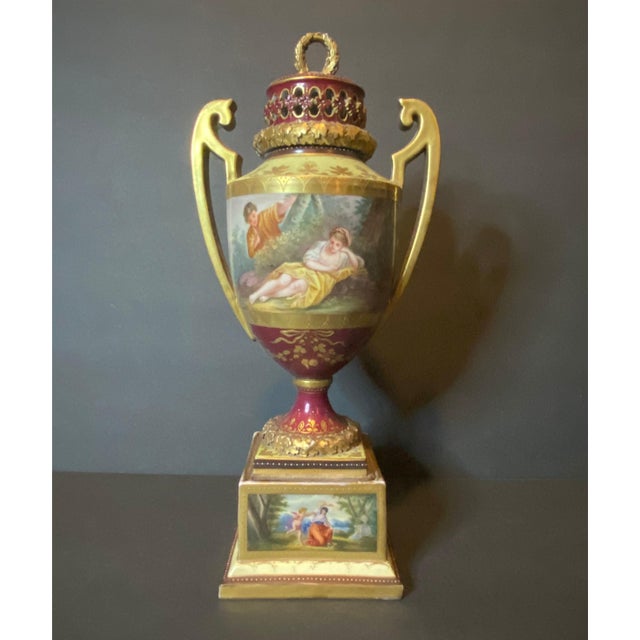 Vienna-style porcelain two-handled pedestal urn. Made in Germany in early 19th Century. Good condition with some slight...
