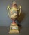 Vienna-style porcelain two-handled pedestal urn. Made in Germany in early 19th Century. Good condition with some slight...