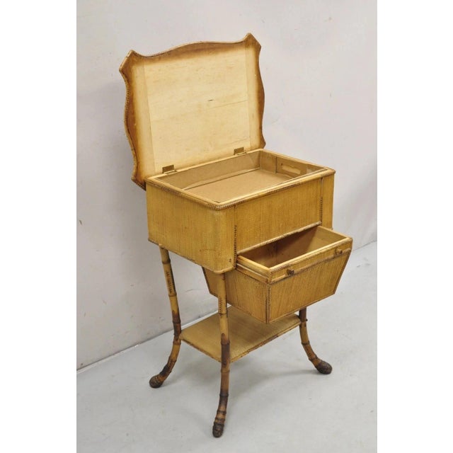 Antique English Victorian Bamboo Rattan Sewing Box Work Stand Side Table. Item features a single drawer, lower shelf, flip...