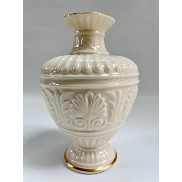 Timeless vintage Lenox vase beautifully detailed in relief with 14K gold trim to bottom and top. In like new condition.