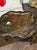 The product is an early 20th century English tole low table. This low table showcases a classic design and craftsmanship...
