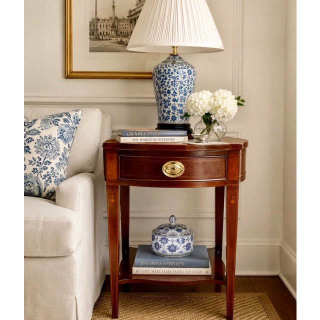 A mahogany side table from Baker Furniture’s Historic Charleston Collection, with a shaped top, satinwood inlay, one...