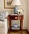 A mahogany side table from Baker Furniture’s Historic Charleston Collection, with a shaped top, satinwood inlay, one...