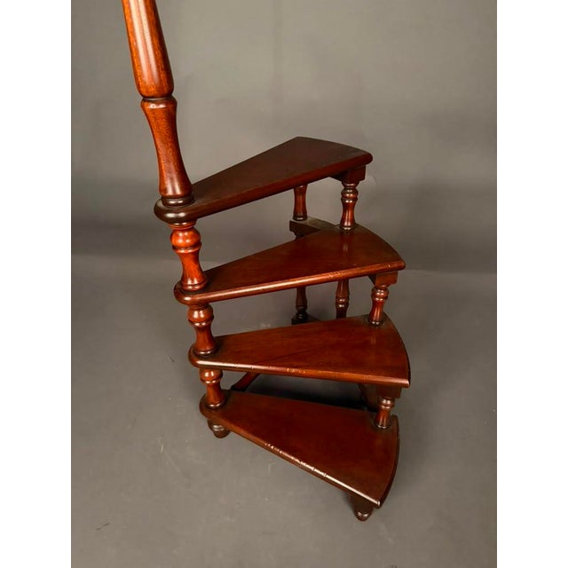Distinctive English mahogany custom spiral library steps featuring four steps that wind upward around a central turned...