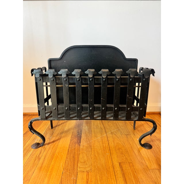 Listing is for an antique black wrought iron fire basket. The interior of the basket has 3 brass rods that create...