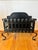 Listing is for an antique black wrought iron fire basket. The interior of the basket has 3 brass rods that create...
