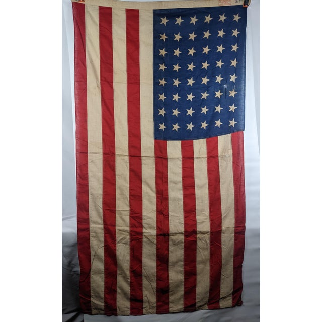 A wonderfully aged vintage 48-star American flag by Lexington, retaining its original printed maker's mark along the...