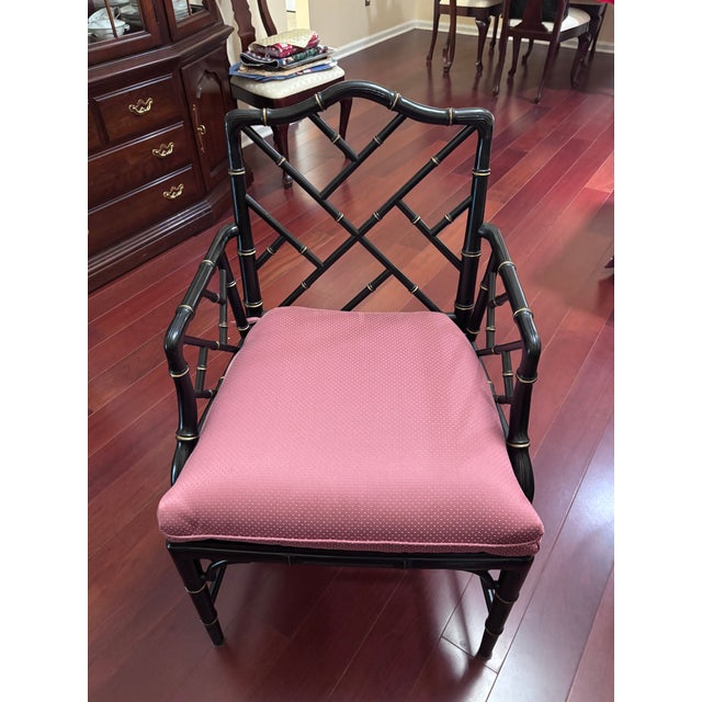 Elegant pair of Chippendale armchairs featuring a classic faux bamboo frame with an intricate lattice-back design. The...