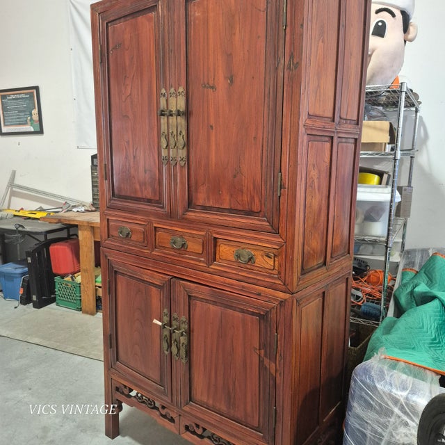 Exceptionally fine early 19th century Chinese elm armoire. Two upper doors open to an interior with single shelf and two...