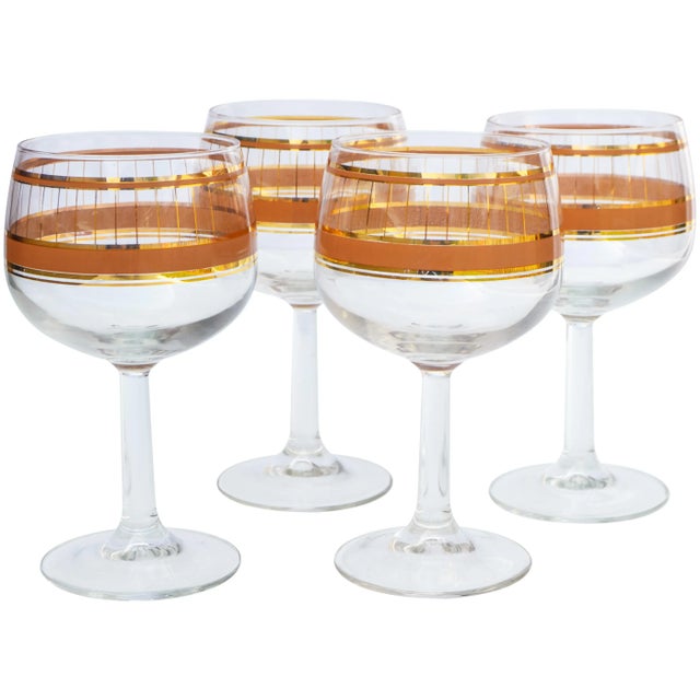 Set of four midcentury culver glasses with an intricate golden pattern and ornate bands in bronze. This beautiful accent...