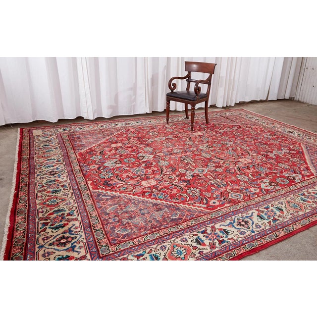 Fantastic traditional antique mahal rug featuring a field with triangular corners. The vivid colors stand out especially...
