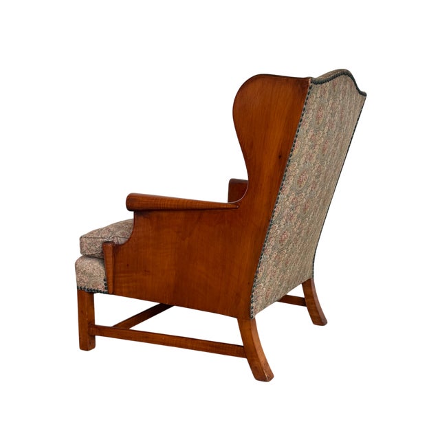 This is a vintage 1940's Stickley wingback lounge chair featuring a beautifully figured cherry frame with sculptural...