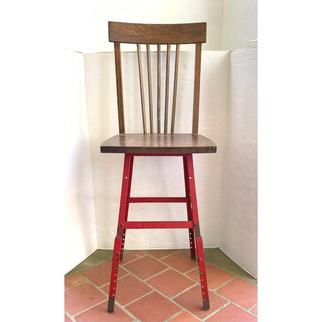 This piece is an interesting marriage of two styles, a classic spindle back oak seat top, and a steel metal base with...